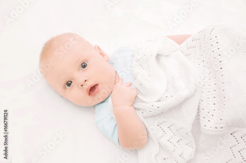 Emotional baby lying in cra...