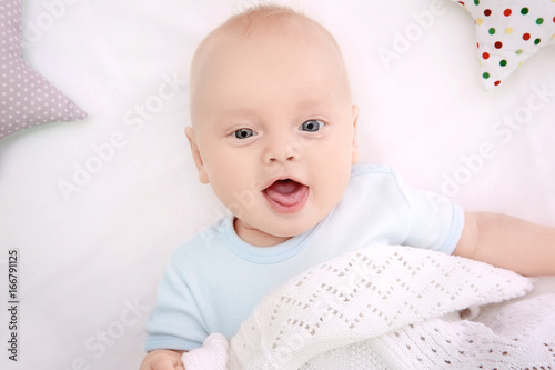 Emotional baby lying in cra...