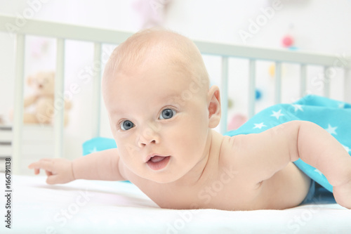 Emotional baby lying in cra...