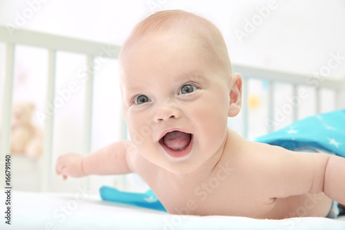 Emotional baby lying in cra...