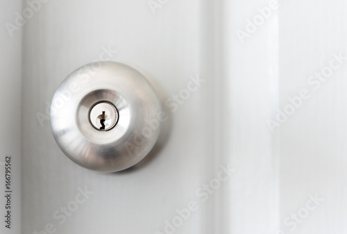 white door with metal doorknob is regular lock style in a house.