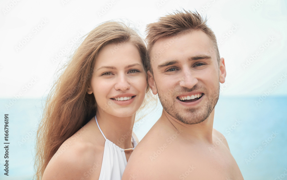 Young loving couple on seashore Young loving couple on seashore