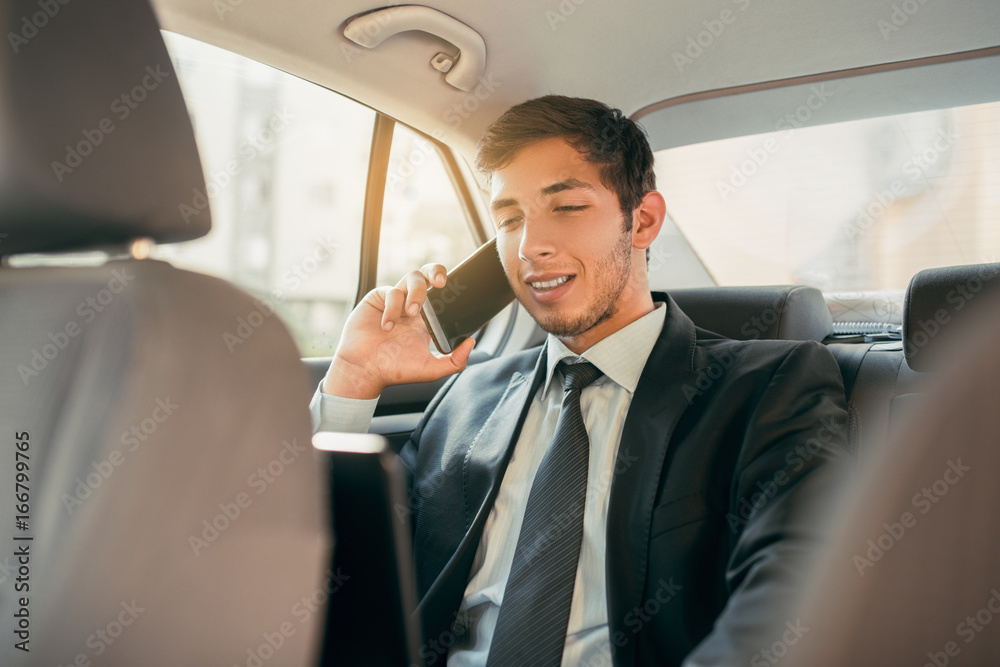 Young businessman working inside the car Young businessman working inside the car