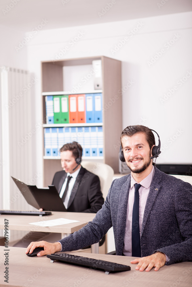 Two men from Customer service support working in office. Professional online and telephone assistant support Two men from Customer service support working in office. Professional online and telephone assistant support