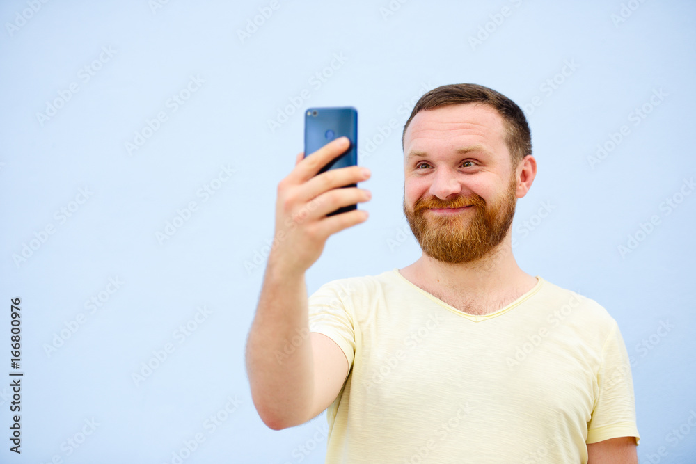 A man makes faces in a funny and humorous phone makes serious faces, an advertising company A man makes faces in a funny and humorous phone makes serious faces, an advertising company