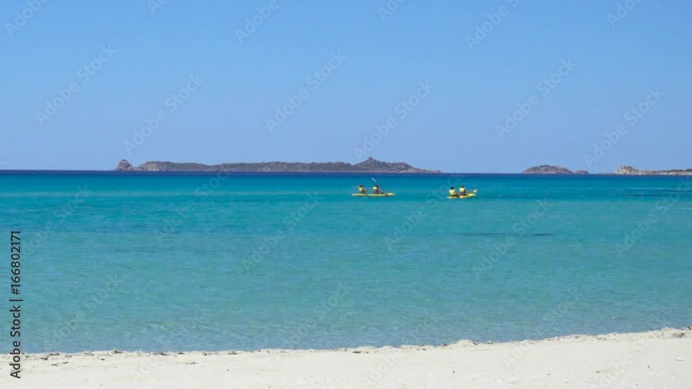 People Kayaking on a White Wild Mediterranean Sea Beach in Italy with Clear Blue Water People Kayaking on a White Wild Mediterranean Sea Beach in Italy with Clear Blue Water
