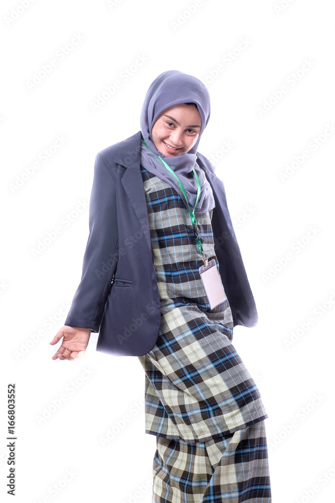 A beautiful, confident Muslim woman with a happy expression wearing hijab, suit and wearing a blank ID tag or name card on a lanyard holding cell phone isolated on white background. A beautiful, confident Muslim woman with a happy expression wearing hijab, suit and wearing a blank ID tag or name card on a lanyard holding cell phone isolated on white background.