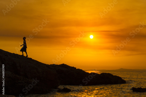 Man climbing at sunset