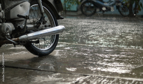 COLOR PHOTO OF MOTORCYCLE AND CLOSE-UP OF RAINDROPS