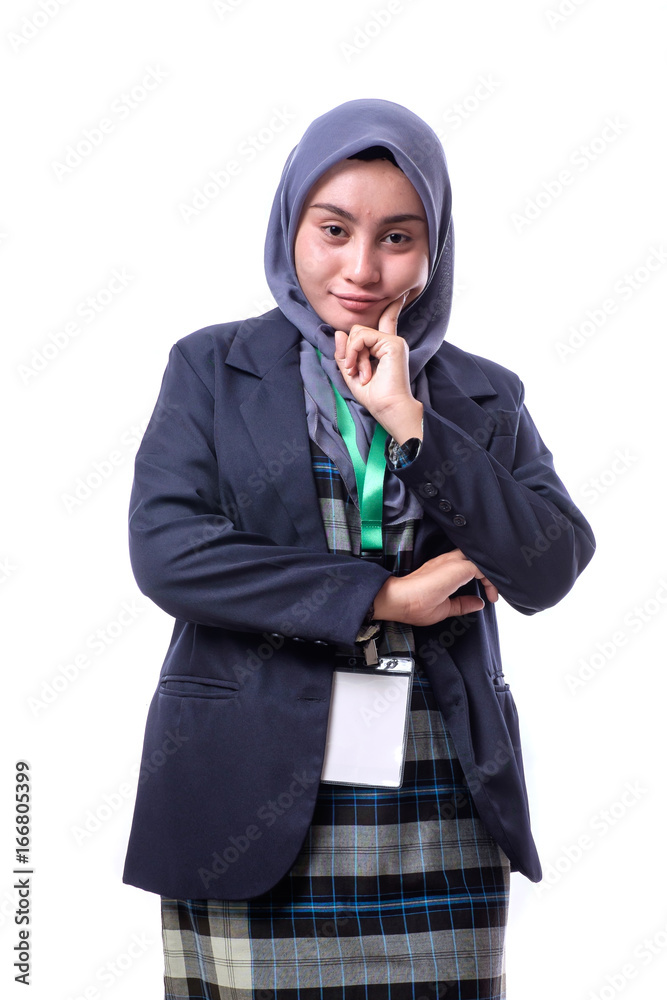 A beautiful, confident Muslim woman wearing hijab, suit and wearing a blank ID tag or name card on a lanyard isolated on white background. A beautiful, confident Muslim woman wearing hijab, suit and wearing a blank ID tag or name card on a lanyard isolated on white background.