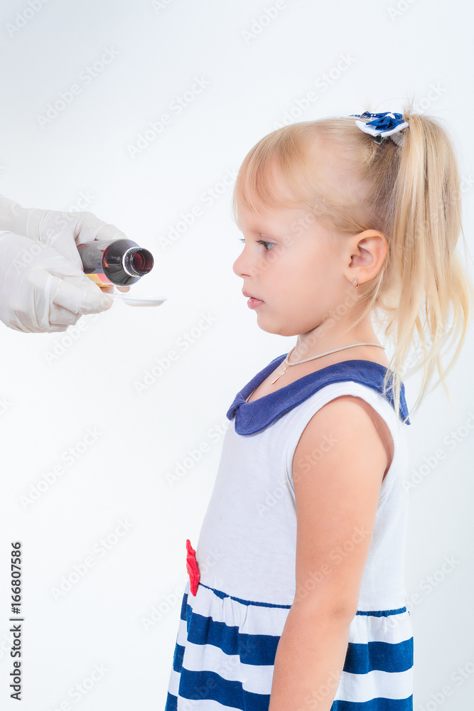 Doctor hand giving spoon dose of medicine liquid drinking syrup to child Doctor hand giving spoon dose of medicine liquid drinking syrup to child