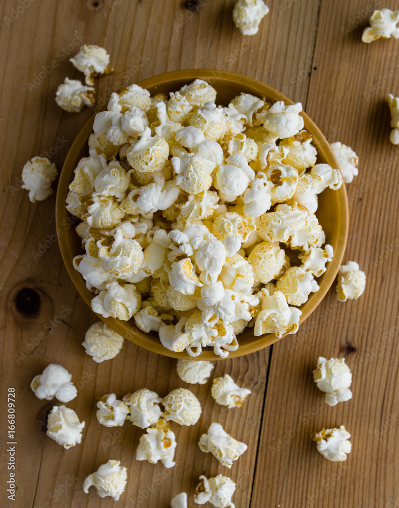 popcorn in wooden bowl popcorn in wooden bowl