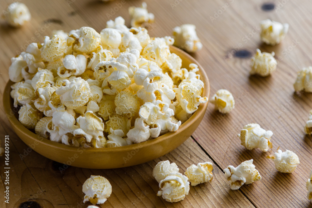 popcorn in wooden bowl popcorn in wooden bowl