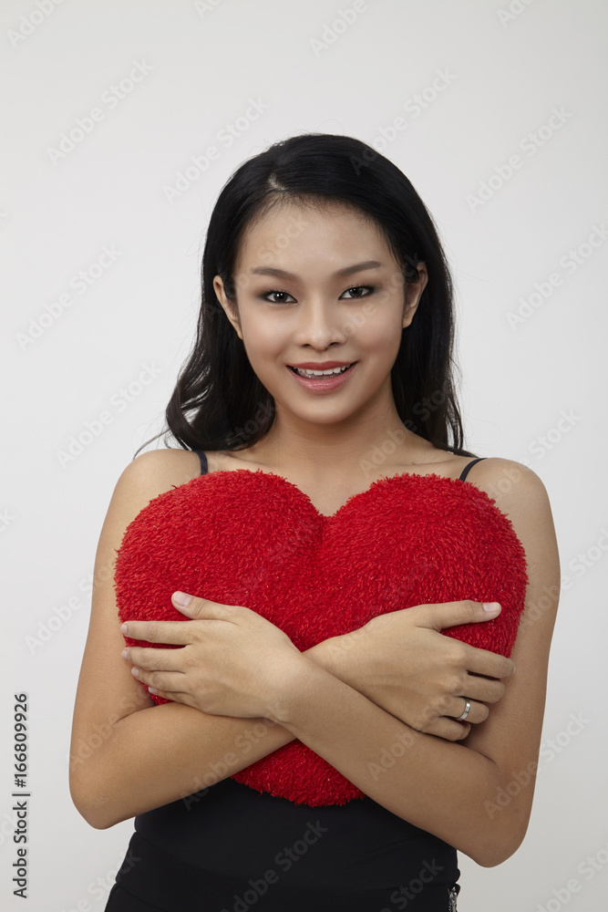 chinese woman hugging heart shape pillow chinese woman hugging heart shape pillow