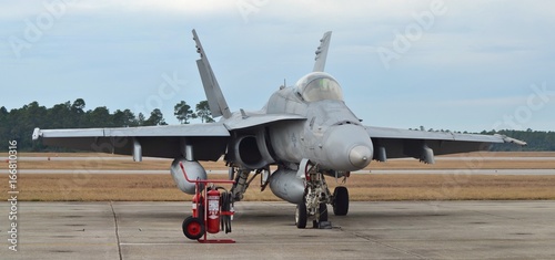 A U.S. Navy F/A-18 Hornet fighter jet prepares for take-off on the runway photo