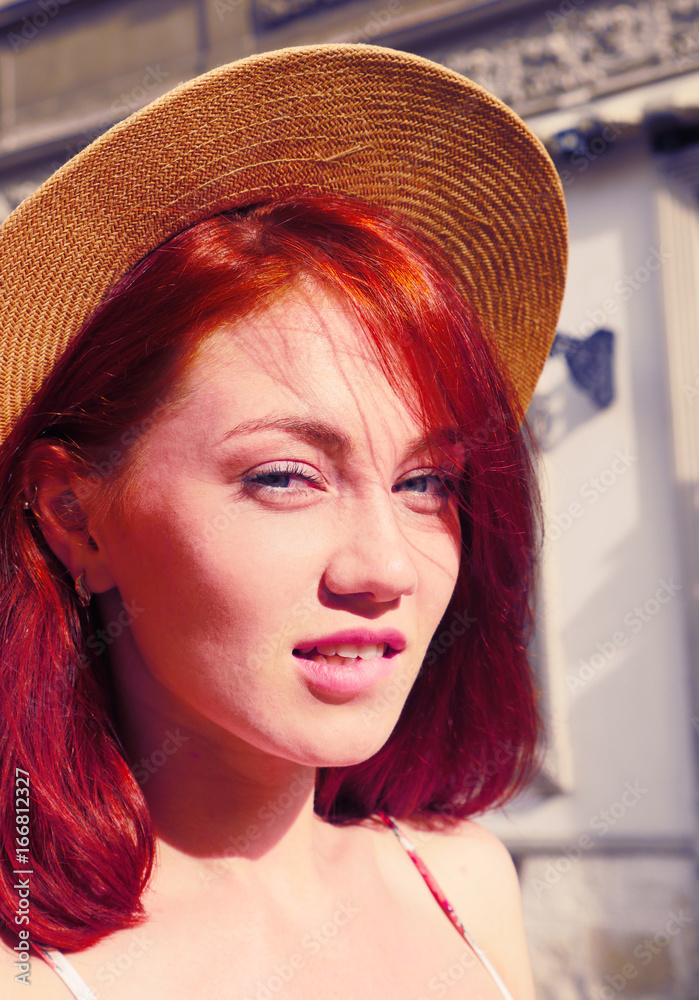 Sexy Red hair girl portrait. Girl in hipster hat posing in front of camera.  Pretty girl