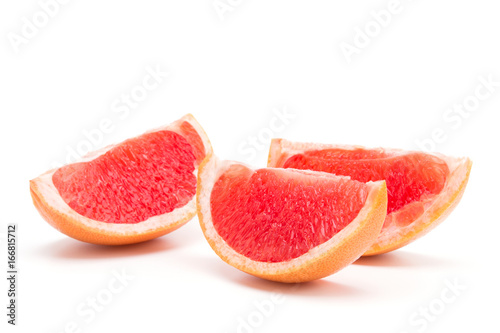 Valokuva Three slices of grapefruit on a white background