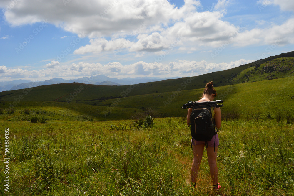 young woman hiking in green landscape young woman hiking in green landscape