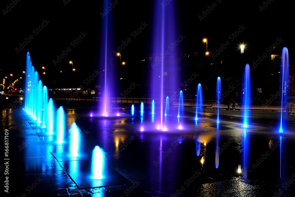City fountain hot summer night and colorful illuminations