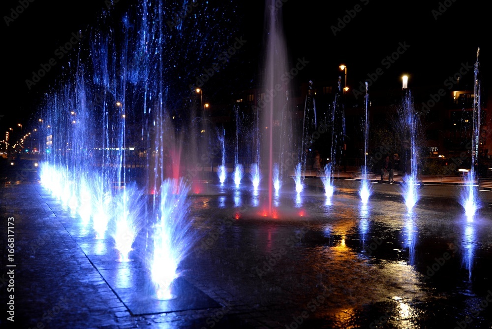 City fountain hot summer night and colorful illuminations