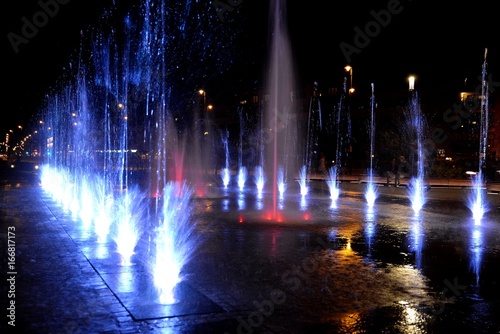 City fountain hot summer night and colorful illuminations
