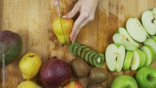 Cutting green pear photo