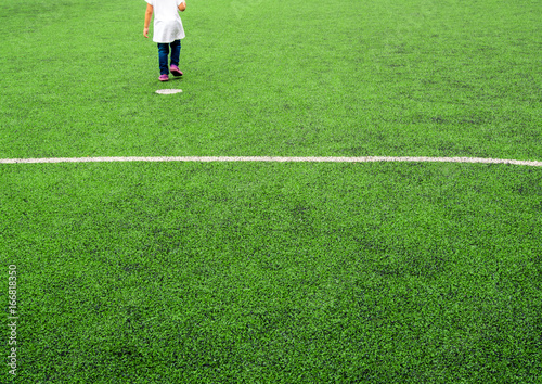 Child play on the artificial turf of the school