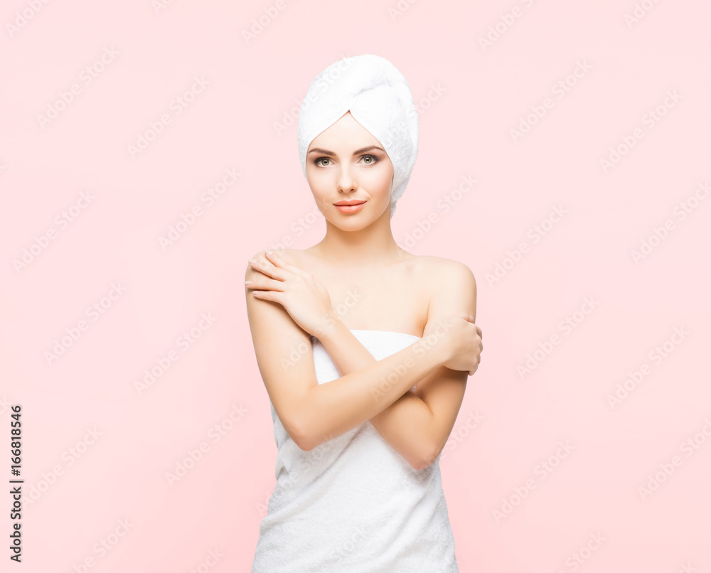Young, beautiful and natural woman wrapped in towel over orange background. Young, beautiful and natural woman wrapped in towel over orange background.