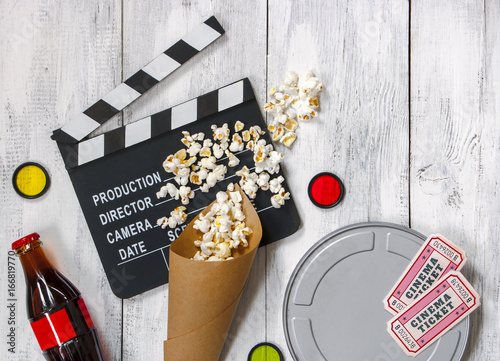 Clapperboard, movie reel and popcorn