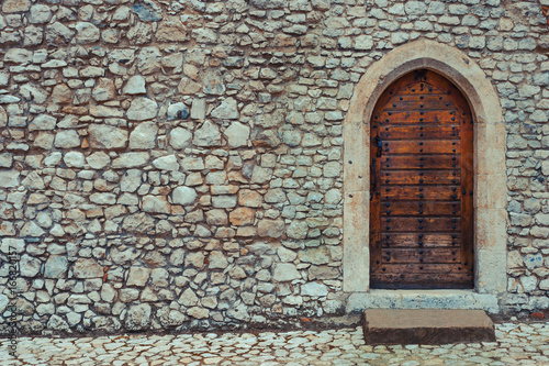 Wooden door in a stone wall
