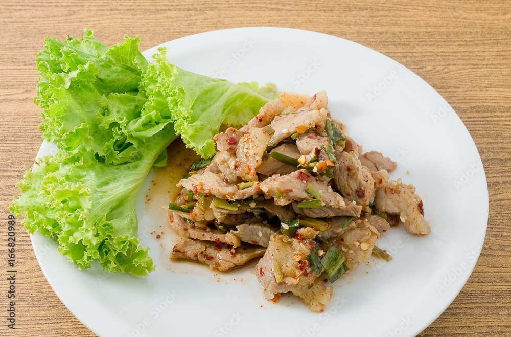 Plate of Spicy Grilled Beef Salad on Wooden Table Plate of Spicy Grilled Beef Salad on Wooden Table