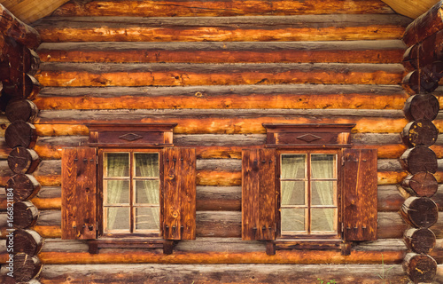 Tableau sur toile Log cabin wall and windows with shutters in Lake Baikal, Russia