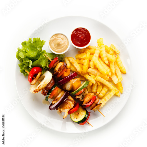 Shashlik - grilled meat and vegetables on white background 