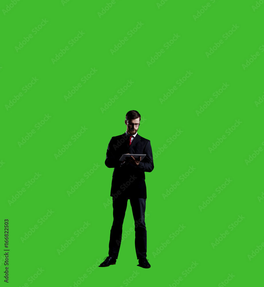 Businessman with computer tablet standing over chroma key background. Business, career job concept.