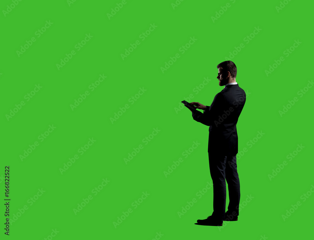Businessman with computer tablet standing over chroma key background. Business, career job concept.