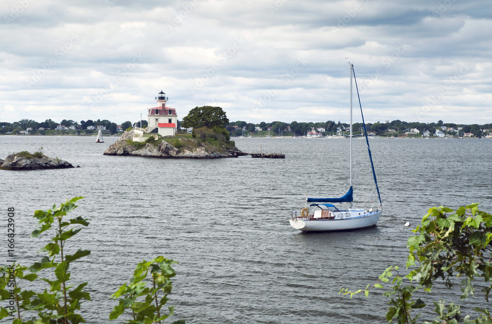 Lighthouse Guarding Sailboat in Rhode Island Harbor