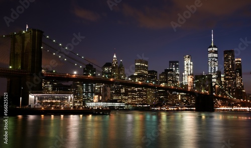 The Brooklyn Bridge and skyline of downtown Manhattan from Brooklyn at night. 