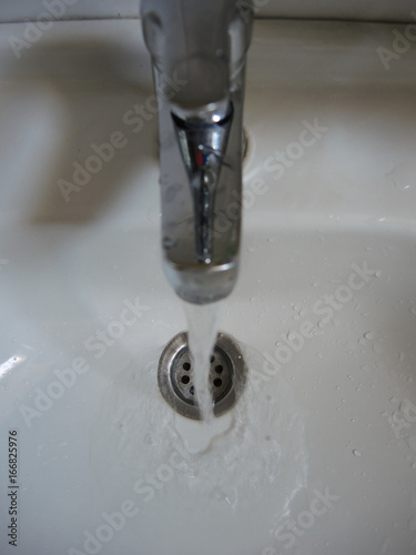 Water flowing from the tap in the sink