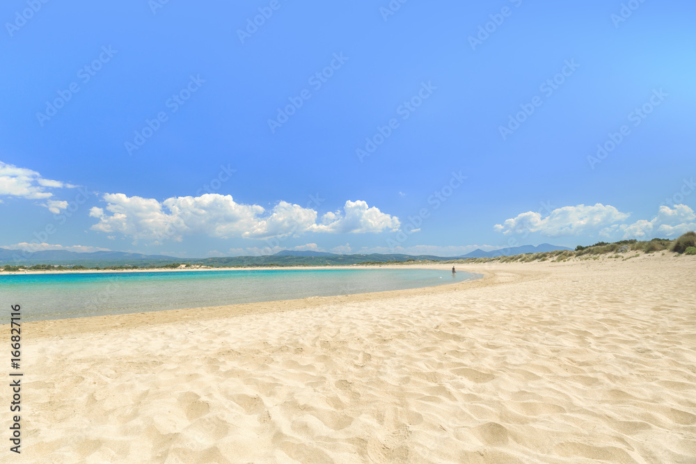 Famous pristine sunny beach Voidokilia in Greece, with beautiful golden beach sand. Summer sunny day skyline scenery. Popular summer resort, travel landmark and vacation destination. Famous pristine sunny beach Voidokilia in Greece, with beautiful golden beach sand. Summer sunny day skyline scenery. Popular summer resort, travel landmark and vacation destination.
