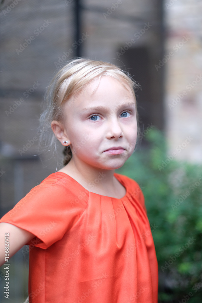 Portrait of a cute blond girl with a smirk on her face Portrait of a cute blond girl with a smirk on her face