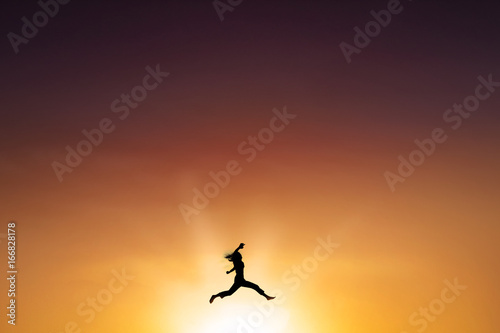 Joyful woman leaps at dusk time