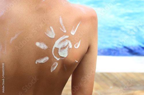 Sunscreen lotion over tan skin, sun protection and vacation concept image.