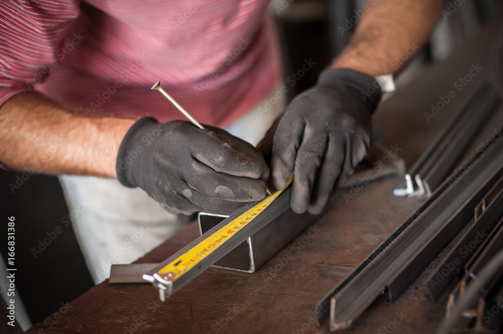 Worker measuring steel with measuring tape Worker measuring steel with measuring tape