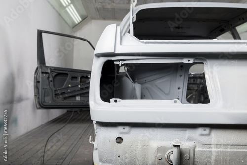 Auto body repair series: White car in paint booth