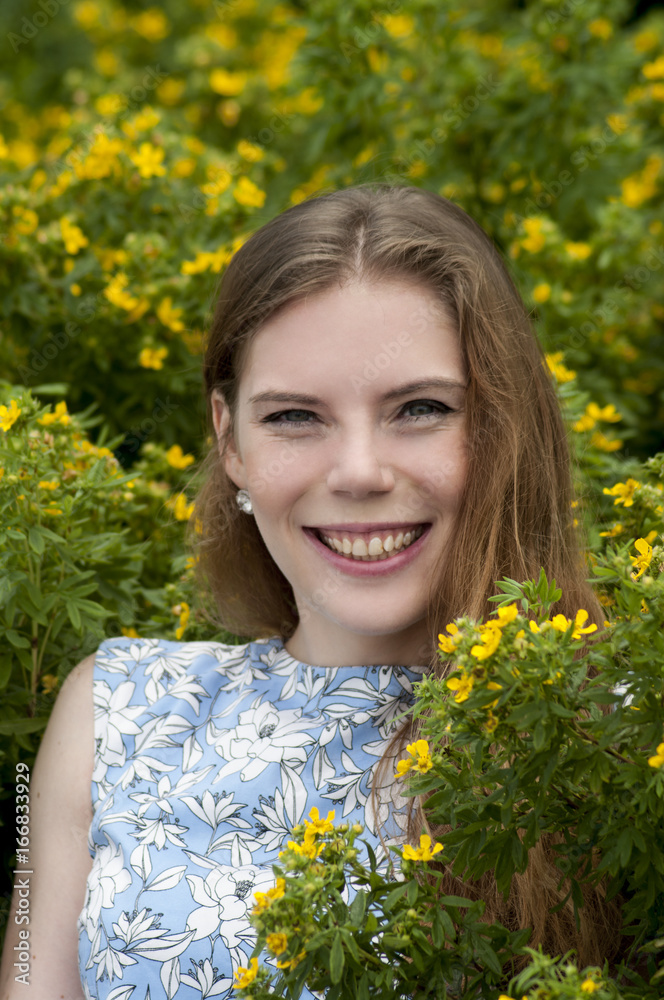 Portrait of girl on a background of yellow flowers. Portrait of girl on a background of yellow flowers.