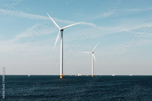 Windmills for the Dutch coast with sailboats