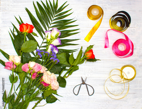 The florist desktop with working tools on wooden background