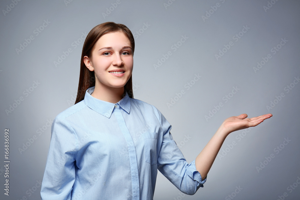 Young girl posing on grey background Young girl posing on grey background