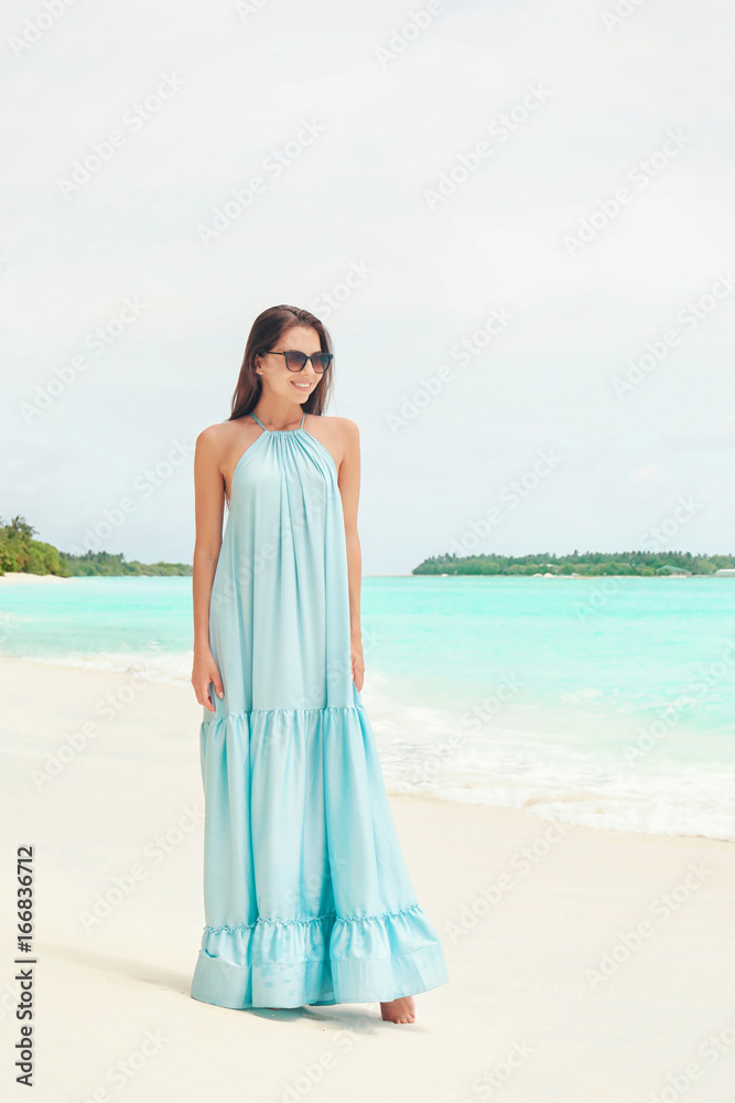 Beautiful young woman on sea beach at resort Beautiful young woman on sea beach at resort