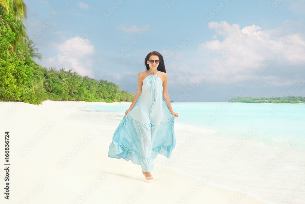Beautiful young woman on sea beach at tropical resort Beautiful young woman on sea beach at tropical resort